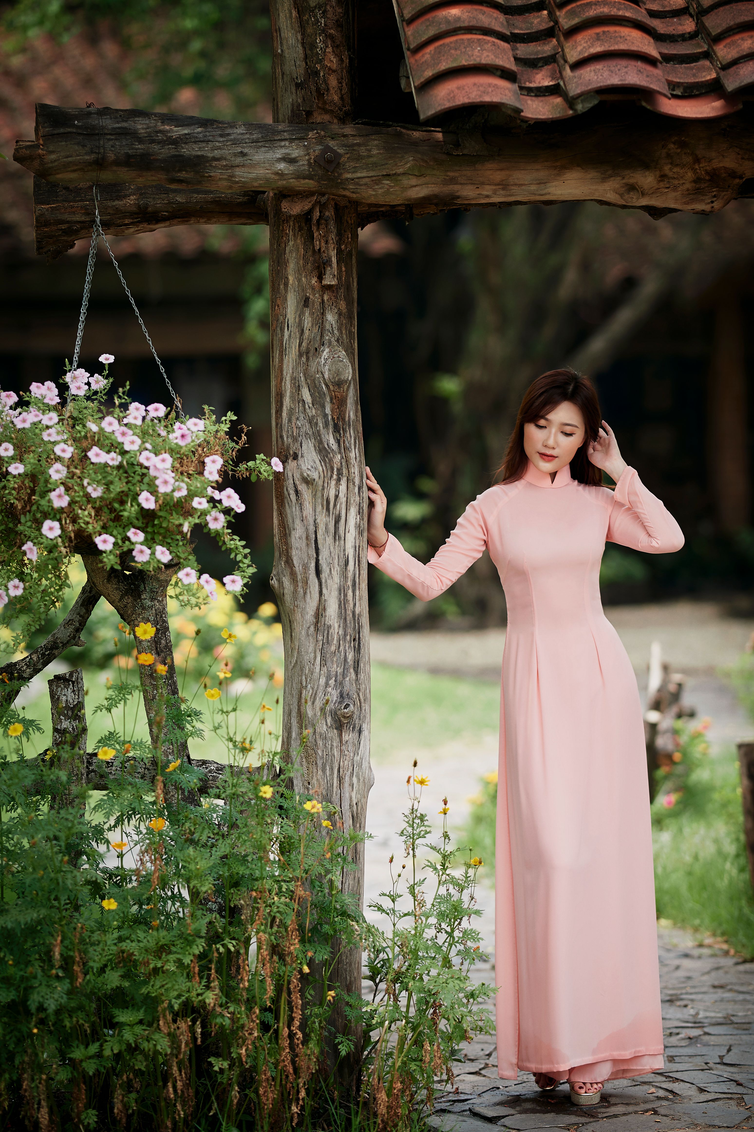 Woman in Pink Dress Standing Beside a Wooden Pole · Free Stock Photo