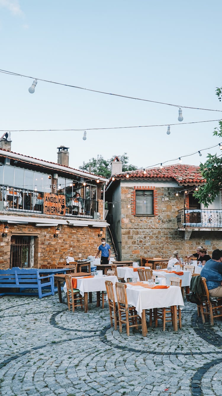 People In Outdoor Restaurant Near Buildings 