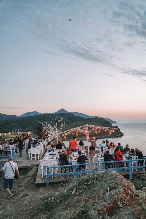 People Dining at a Restaurant near Beach