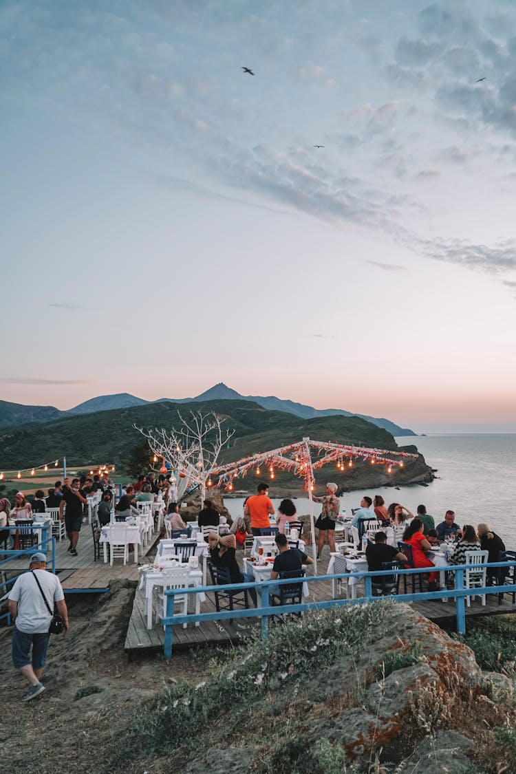 People Dining At A Restaurant Near Beach