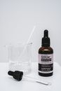 Hair Serum and a Beaker with Liquid