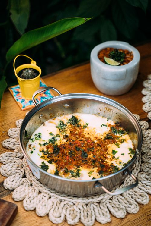 Free Close-up of flavorful cooked beans in a metal pot with vibrant garnishes, perfect for food lovers. Stock Photo