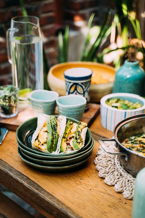 Free Delicious brunch with tacos on a rustic table setting, featuring colorful ceramics in an outdoor setting. Stock Photo