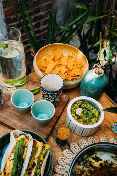 Free A vibrant display of Mexican food including tacos, guacamole, and chips. Perfect for Cinco de Mayo. Stock Photo