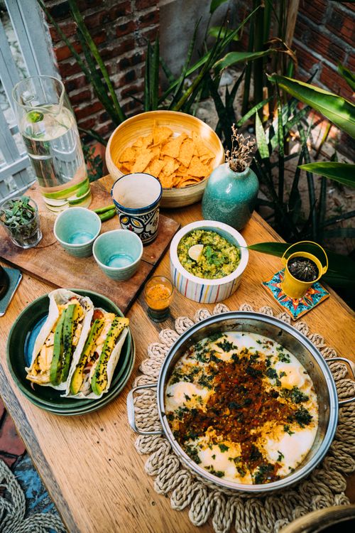 Free Vibrant Mexican brunch spread with nachos, tacos, and dips in a rustic setting outdoors. Stock Photo