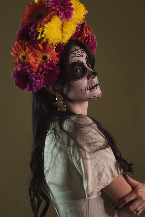 Calavera Catrina in a White Dress and a Headdress Made of Gerberas