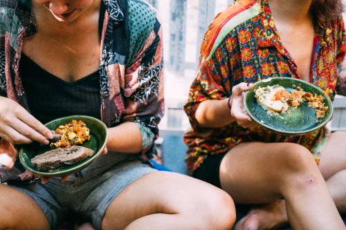 Free Two women sharing Mexican food indoors; vibrant, cultural, intimate setting. Stock Photo