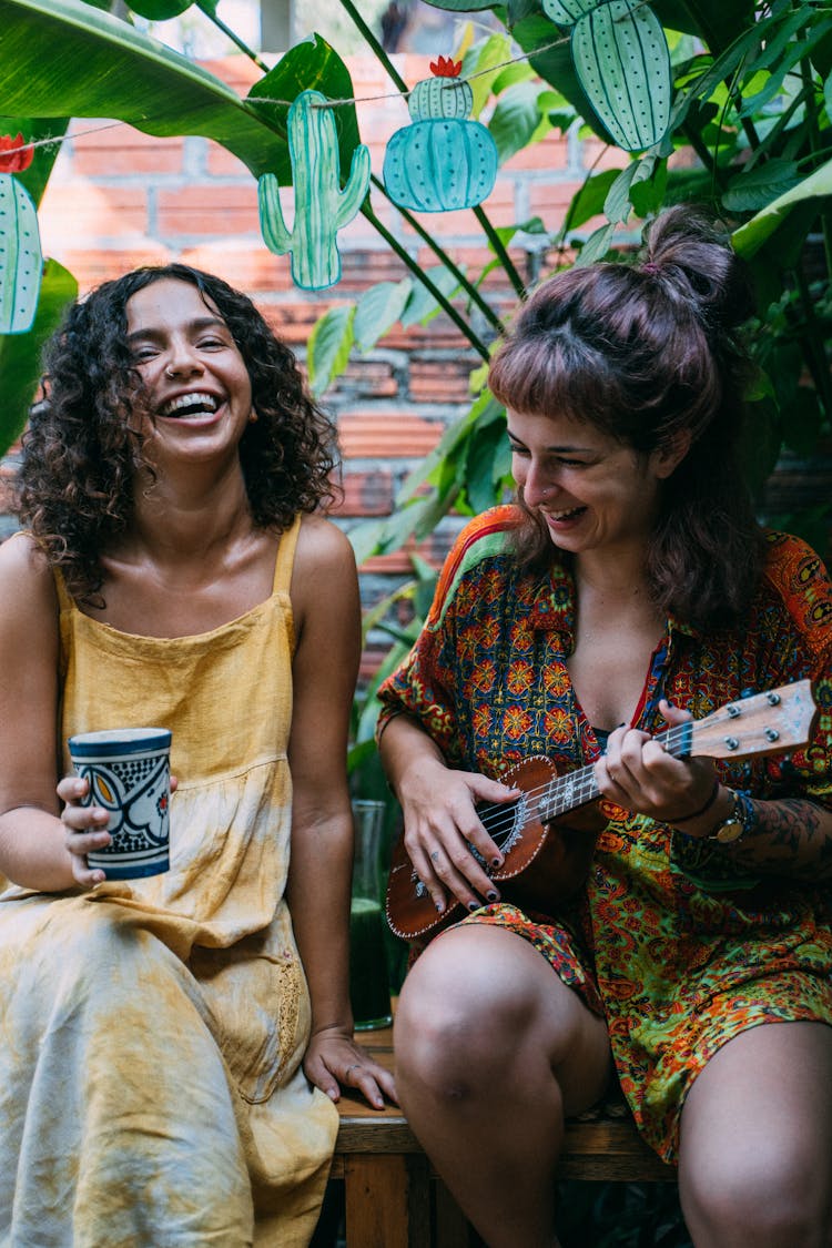 Smiling Woman Playing The Ukulele