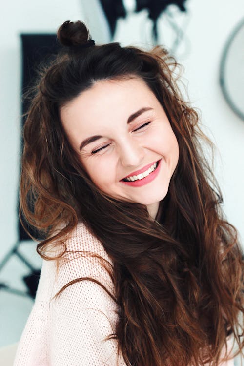 Beautiful Woman in White Knit Shirt Smiling