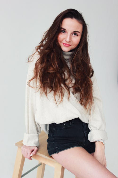 Free Beautiful Model With Brown Wavy Hair Posing at The Camera Stock Photo