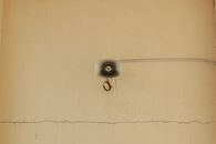 A mounted megaphone on a cracked wall highlights urban decay and communication themes.