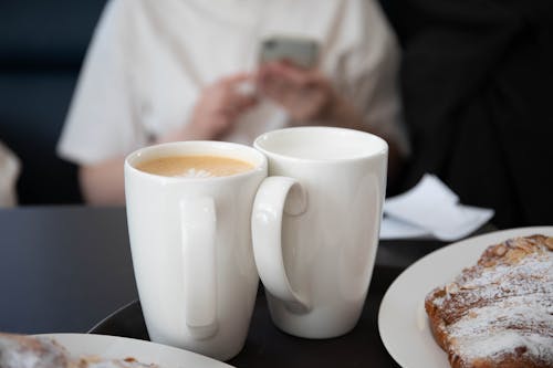 Free Close-up of Mugs with Coffee and Pastry on the Plate  Stock Photo