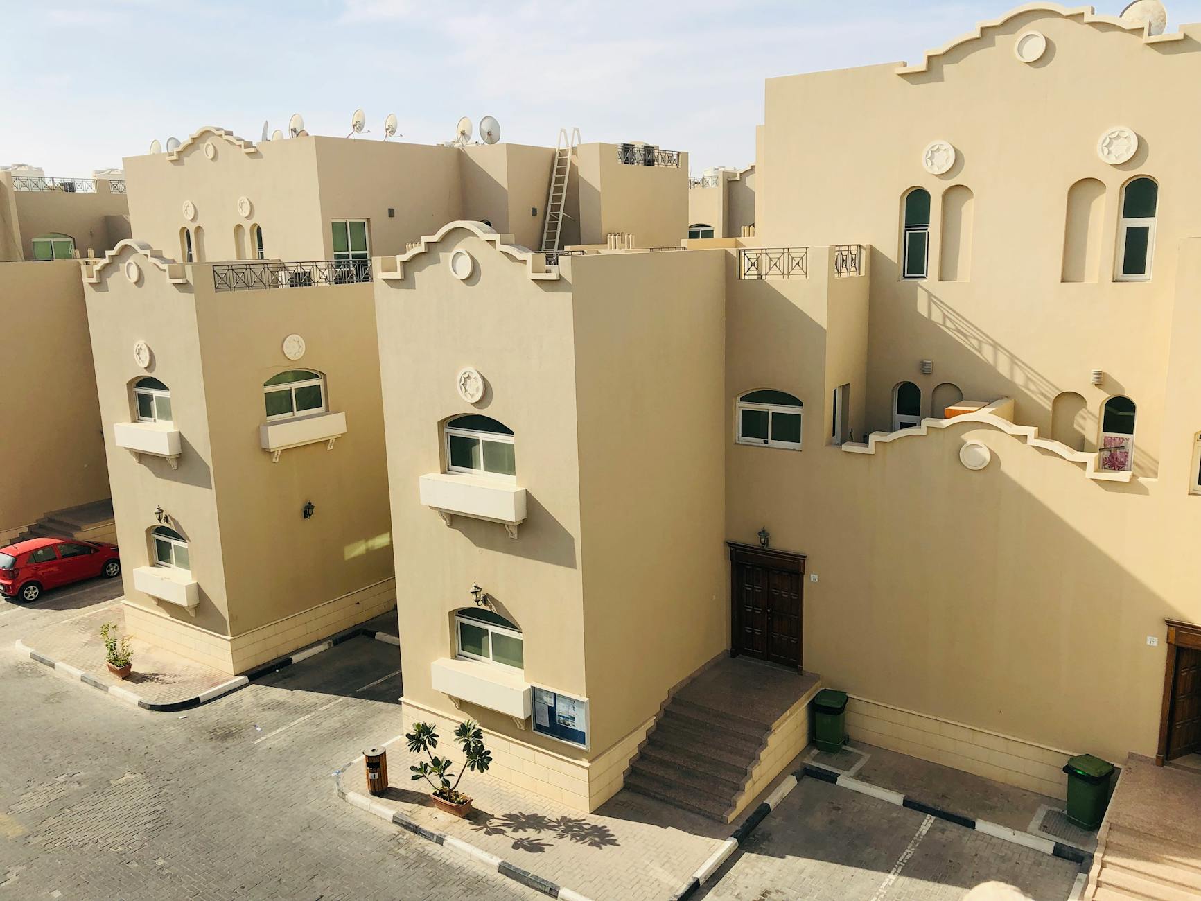 Aerial view of modern architectural homes in Abu Dhabi on a sunny day.