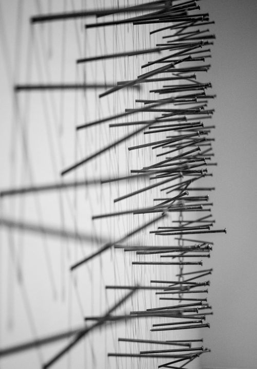 Free Creative abstract composition of metal nails in monochrome. Ideal for modern decor. Stock Photo