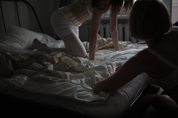 Woman Crawling In A Messy Bed