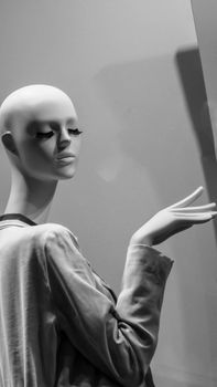 Sophisticated black and white portrait of a mannequin with a thoughtful pose.