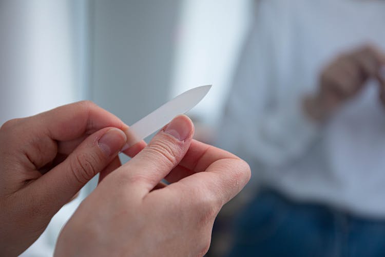 A Person Filing Nail