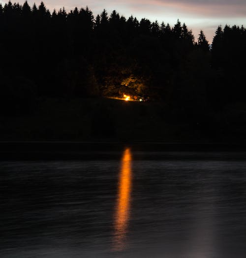 Reflection of Orange Light on Water Surface