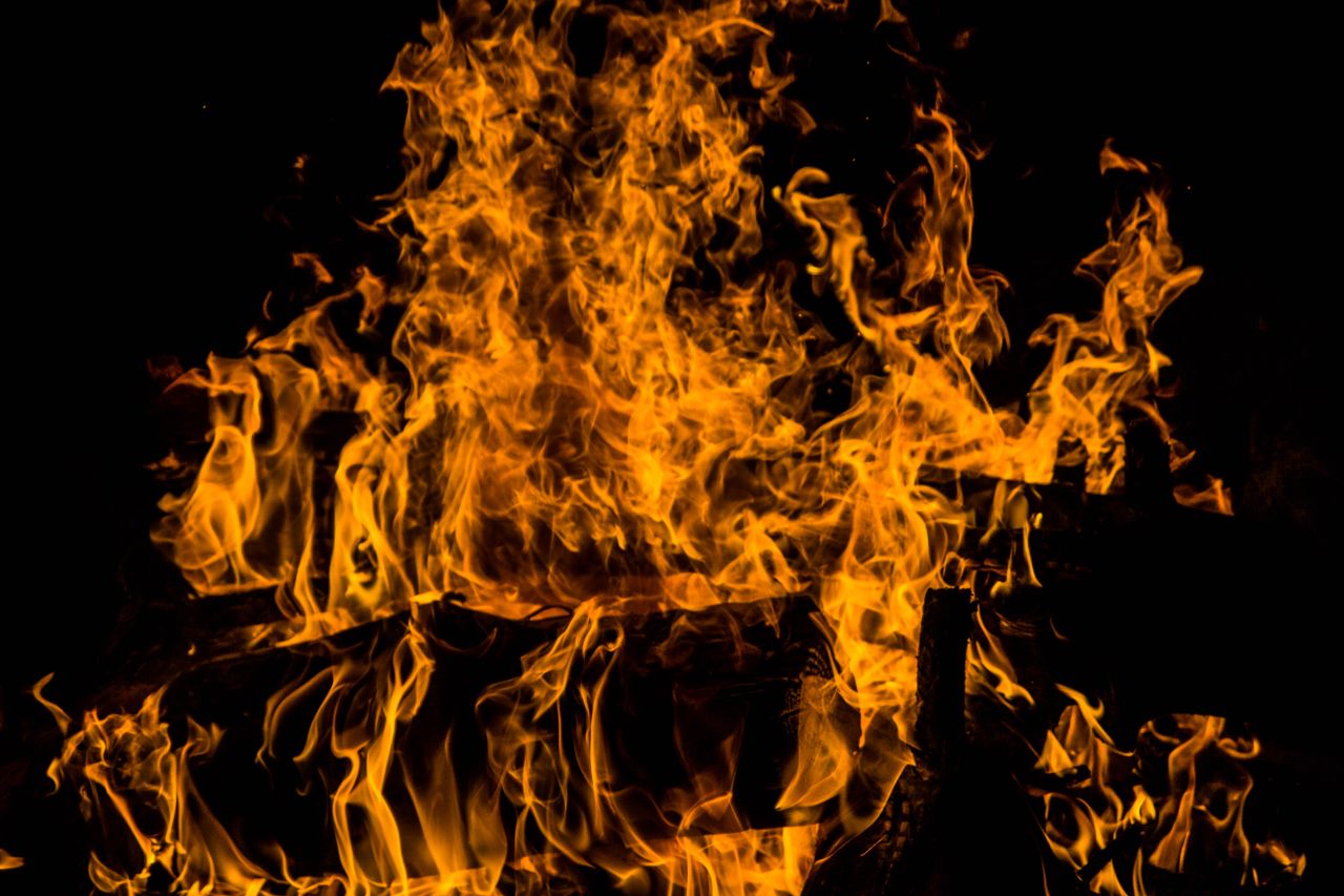 intense yellow and orange flames on a dark backdrop creating a dramati