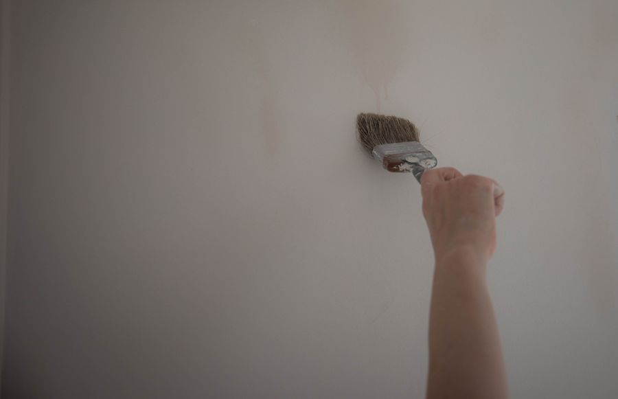 Close detail of paint brush work on an interior wall.