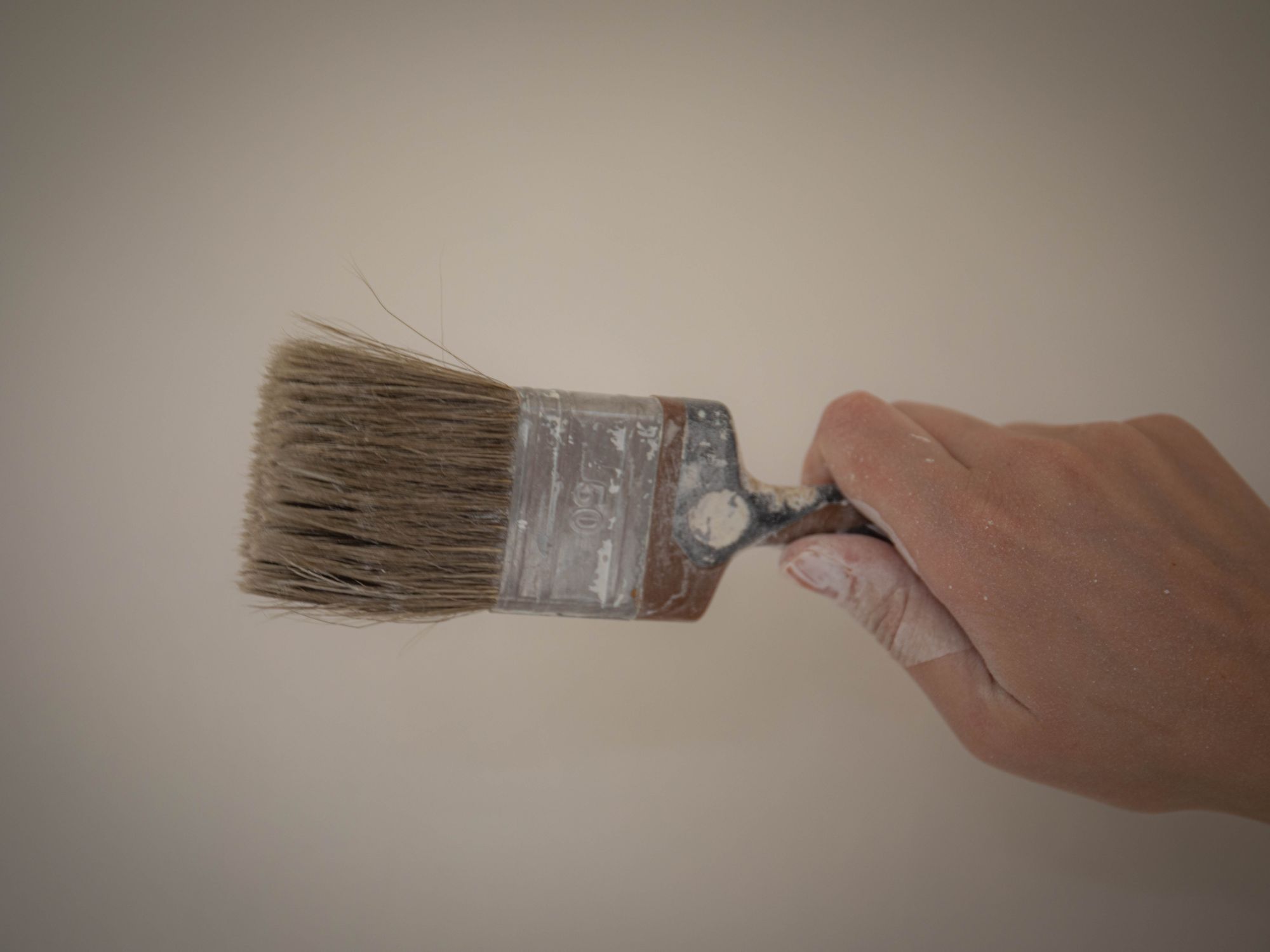 Exterior Painting in Oakleigh Park, Barnet — painter refreshing a house exterior in weatherproof paint