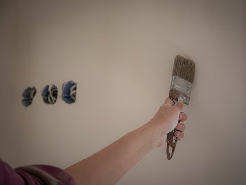 Person Painting White Wall