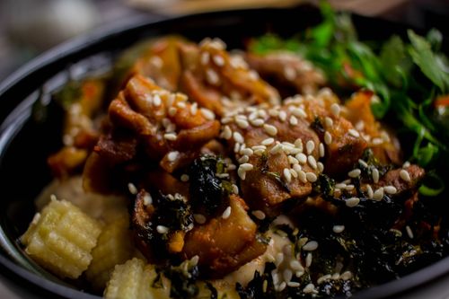Free Close-up of a delicious Asian dish with sesame seeds and garnished vegetables. Stock Photo
