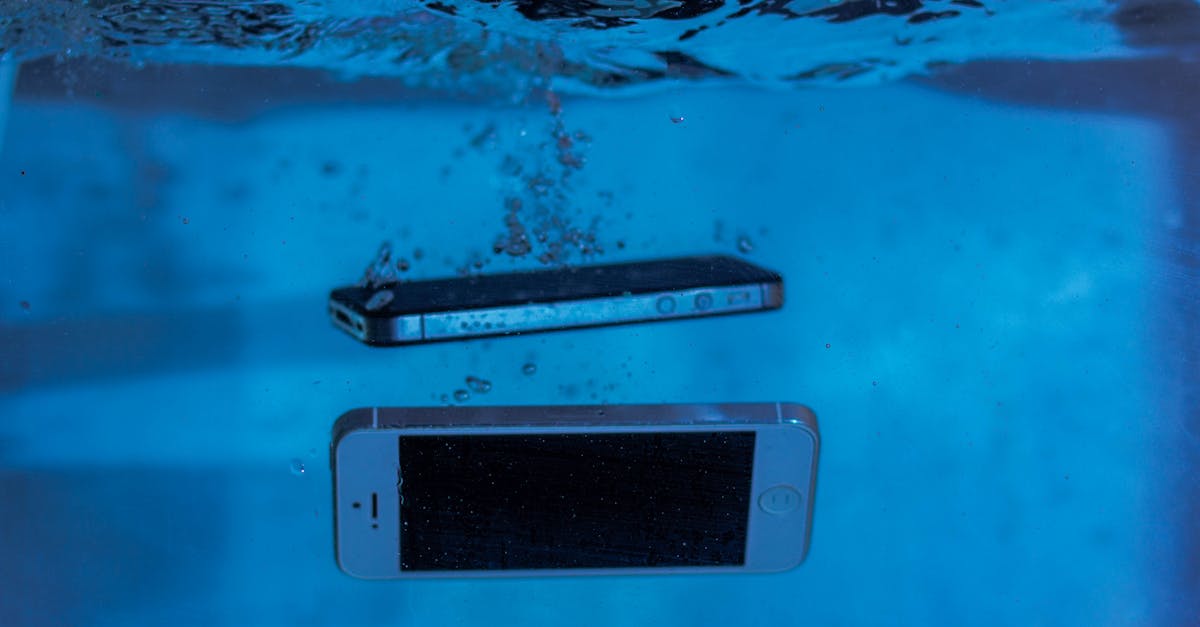 Two smartphones submerged in water, illustrating the concept of waterproof electronic gadgets for travel and outdoor use.