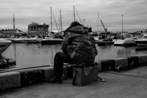 Back View of a Person Fishing on the Harbor