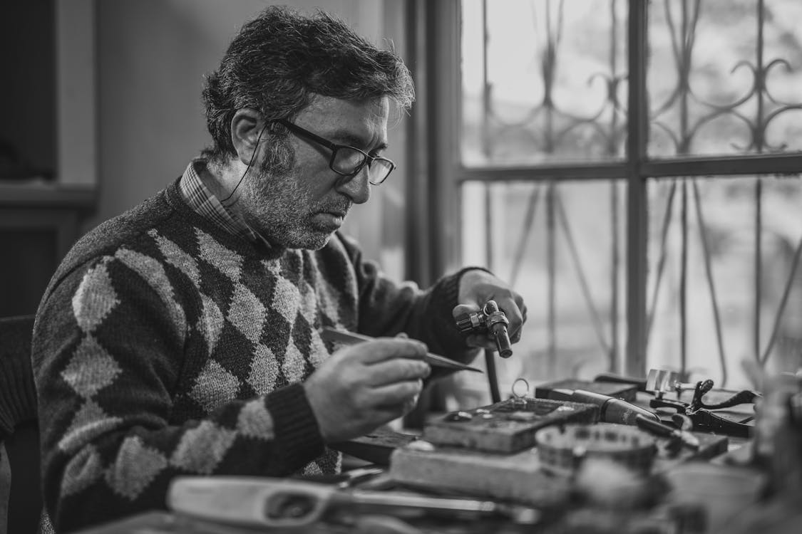 Free Grayscale Photo of Man Holding Tools Stock Photo