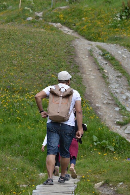 People Walking on a Wooden Pathway