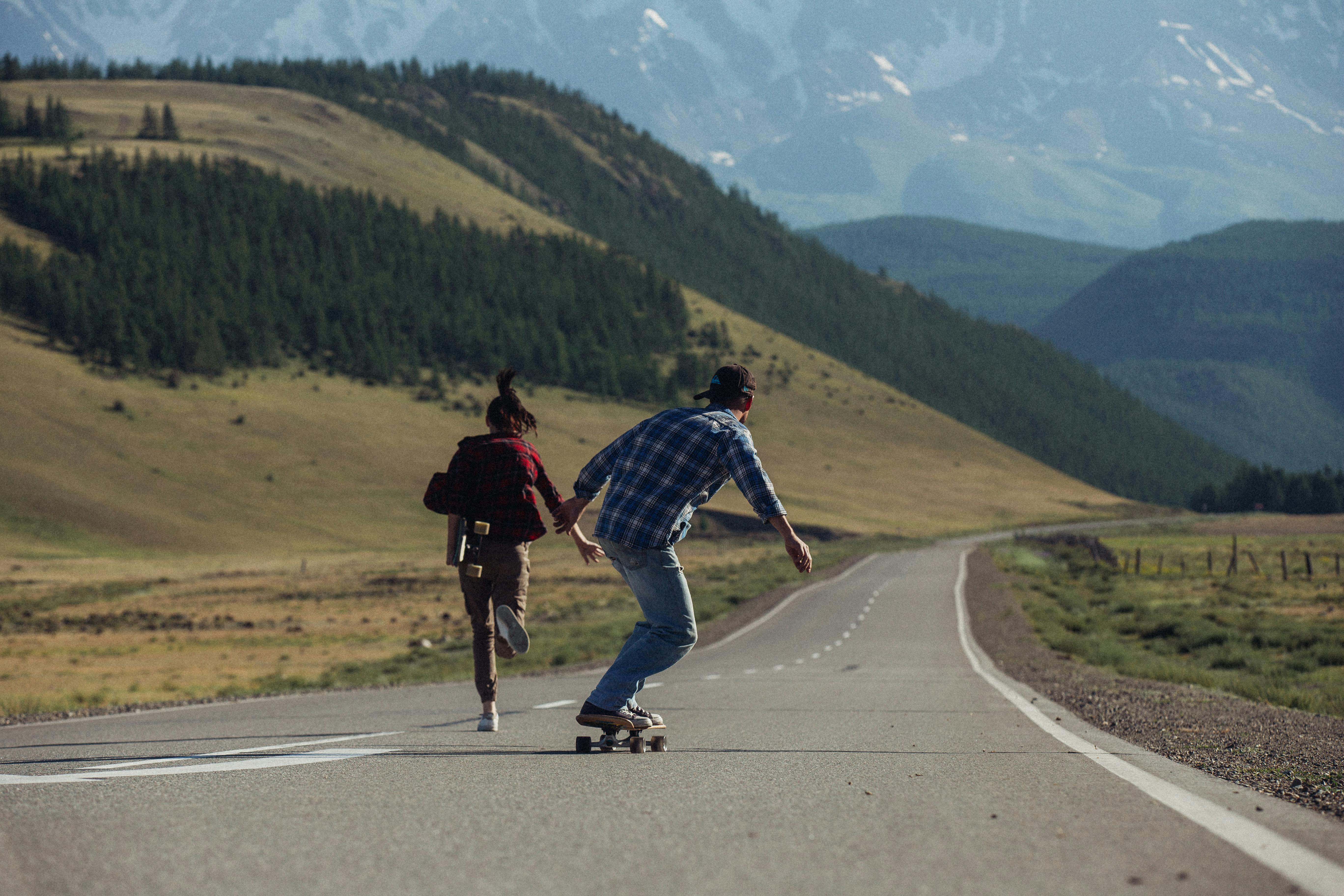 Confident man riding longboard across city street - a Royalty Free Stock  Photo from Photocase