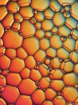 Vibrant macro shot of colorful bubbles forming hexagonal patterns.