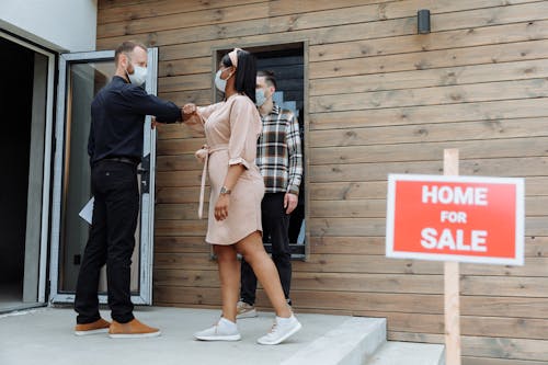 Free A Real Estate Agent Greeting a Client Stock Photo
