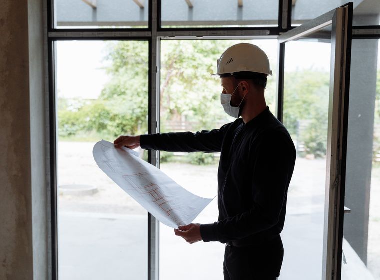 Engineer reviewing a floor plan during construction planning