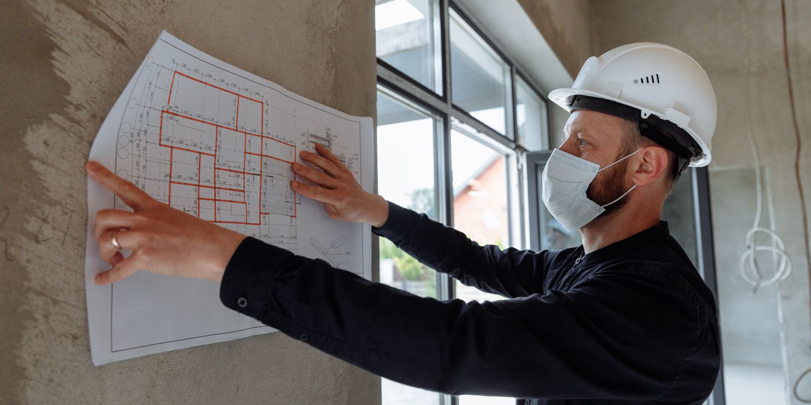 Construction professional reviewing building plans