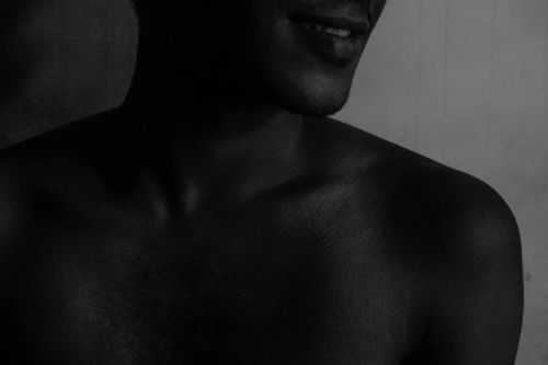 Free Artistic black and white close-up of a male torso with shadow play, capturing texture and mood. Stock Photo