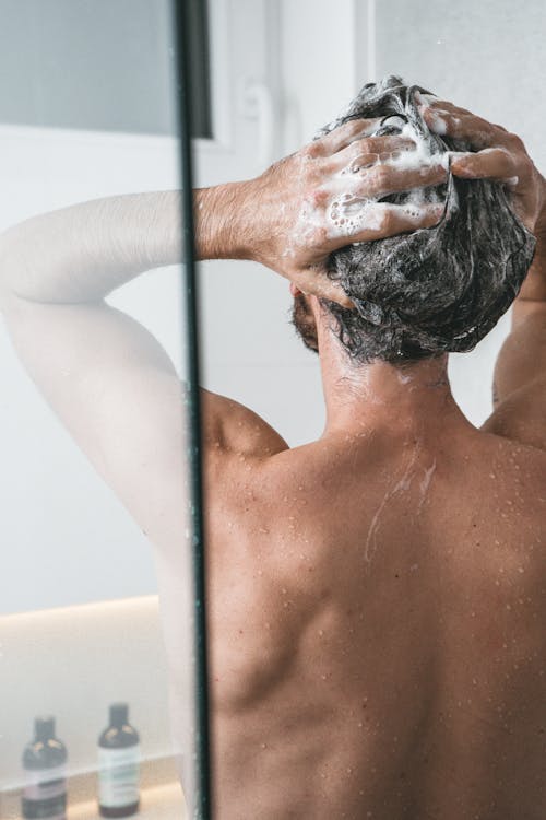 Back View of a Person Taking a Shower 