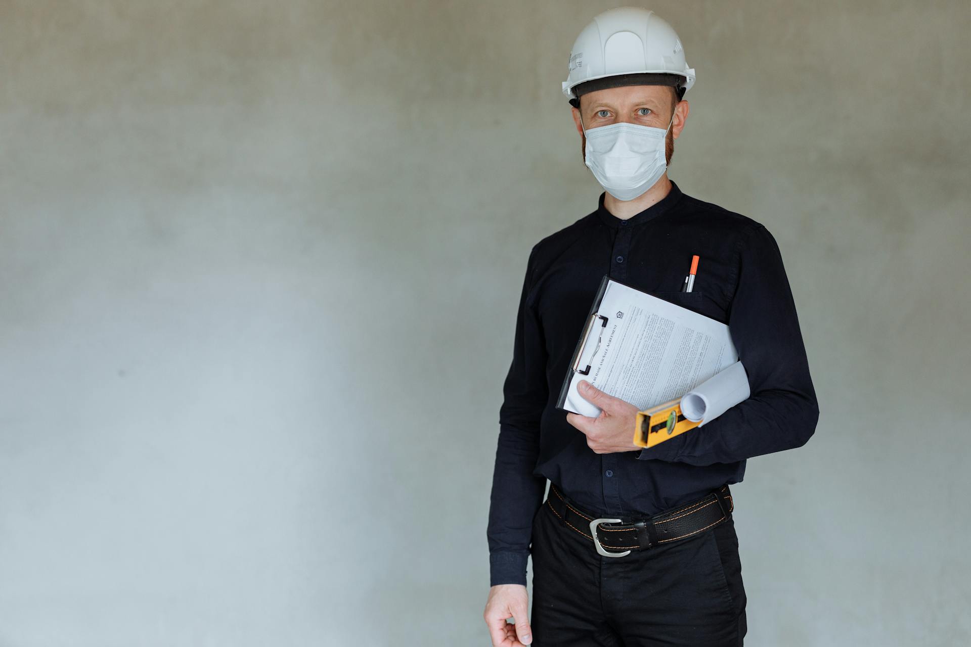 A Man in Business Attire Wearing a Hard Hat