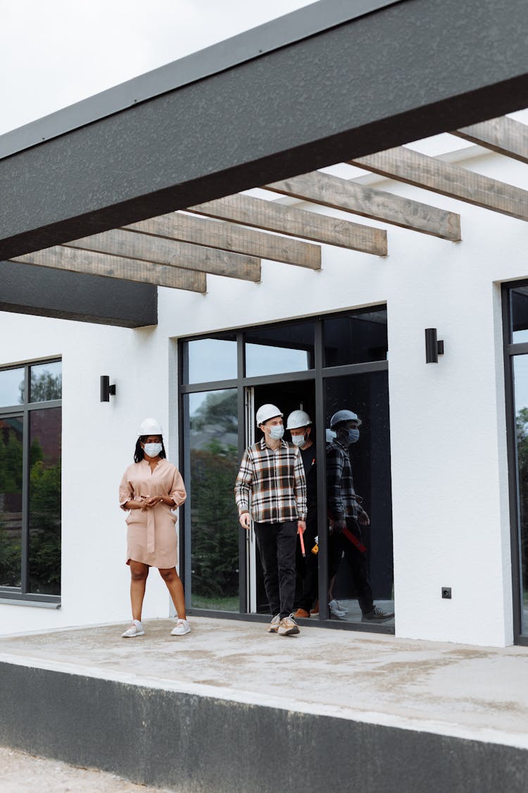 Couple Looking At A New House With A Real Estate Agent