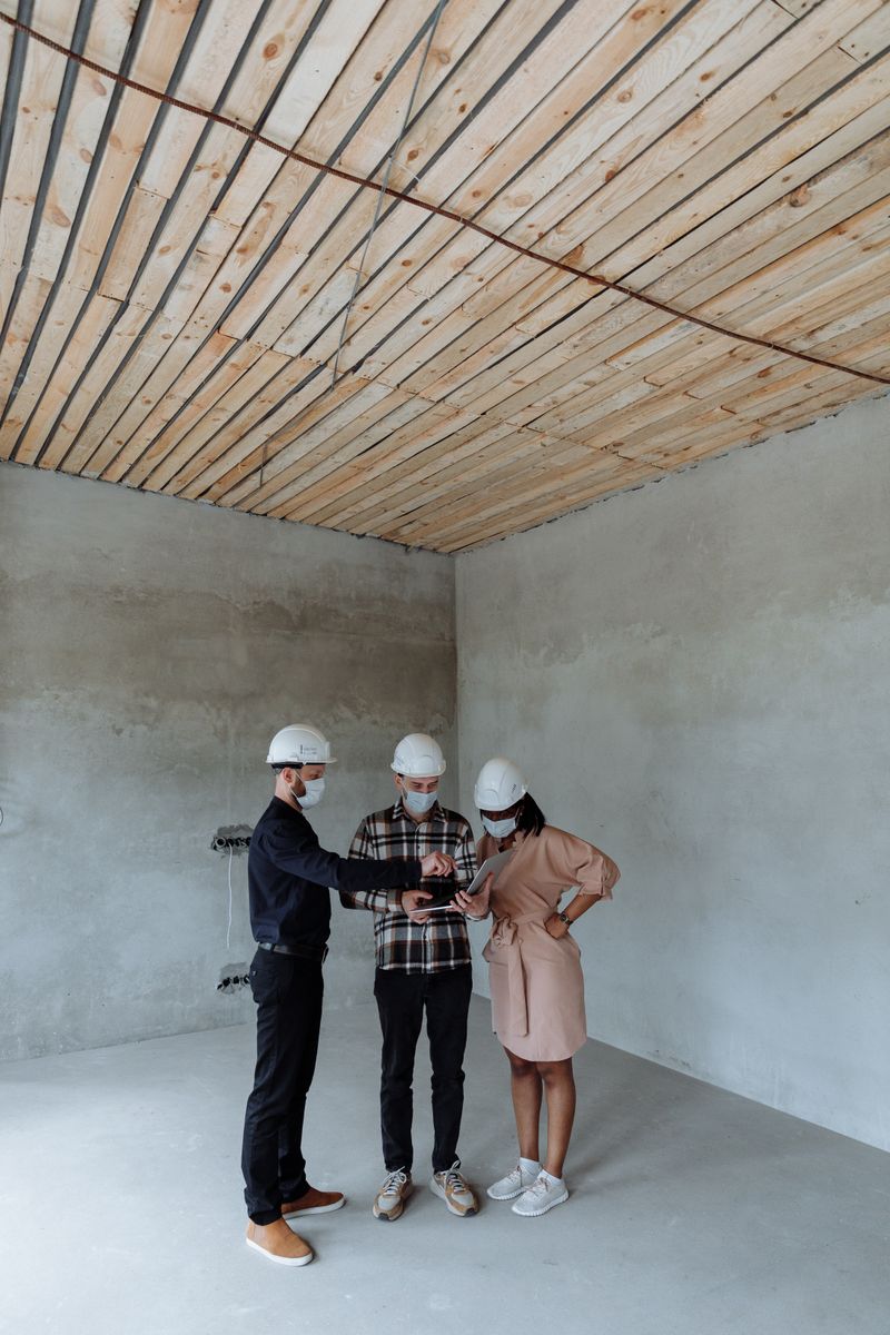 Sales engineers reviewing building plans on site