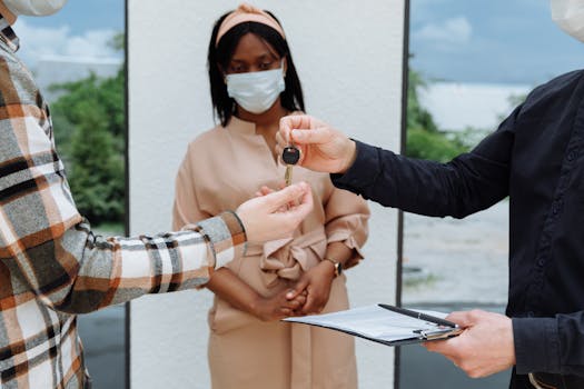 A real estate deal closure with masks during the COVID-19 pandemic, highlighting safety.