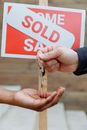 Person Handing Out Keys to Another Person