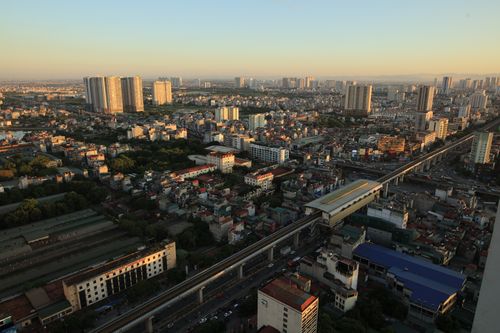 Free Aerial view of Hanoi's urban landscape featuring high-rise buildings and dense housing. Stock Photo
