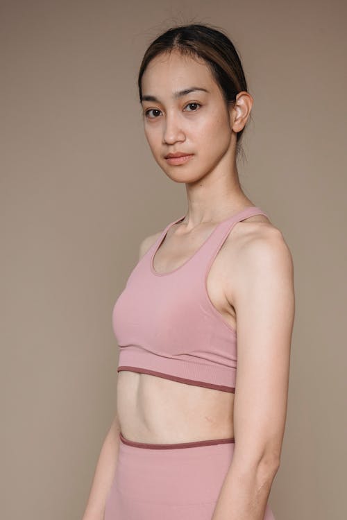 Photo of a Woman in Pink Activewear Looking at the Camera · Free Stock Photo