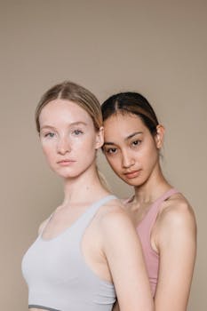 Two women in activewear posing together, highlighting diversity and fitness.