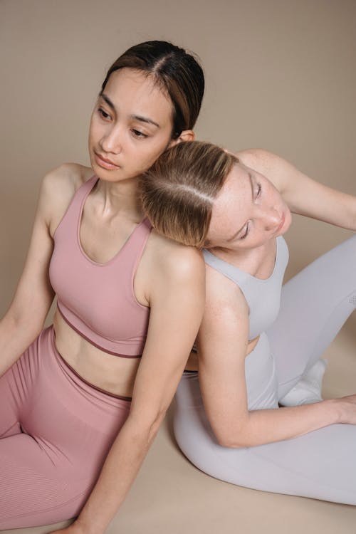 A High Angle Shot of Women Wearing Sports Bra while Sitting Together