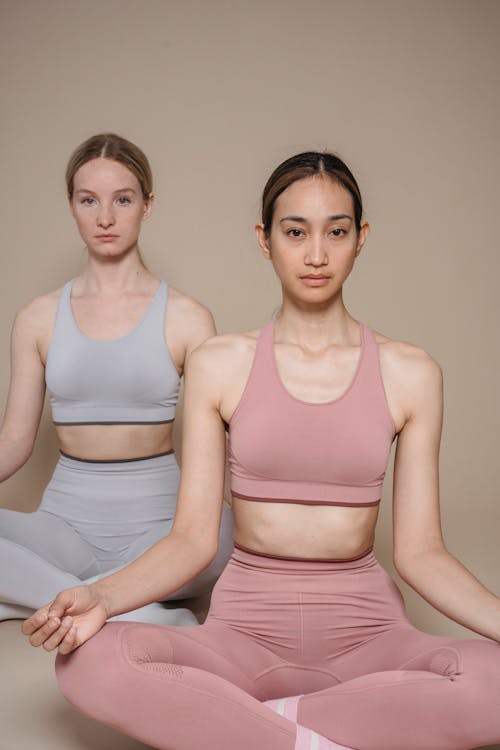 Women in Activewear Posing While Sitting on the Floor