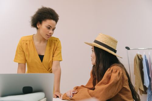Free Two women collaborating on business planning in a modern office setting. Stock Photo