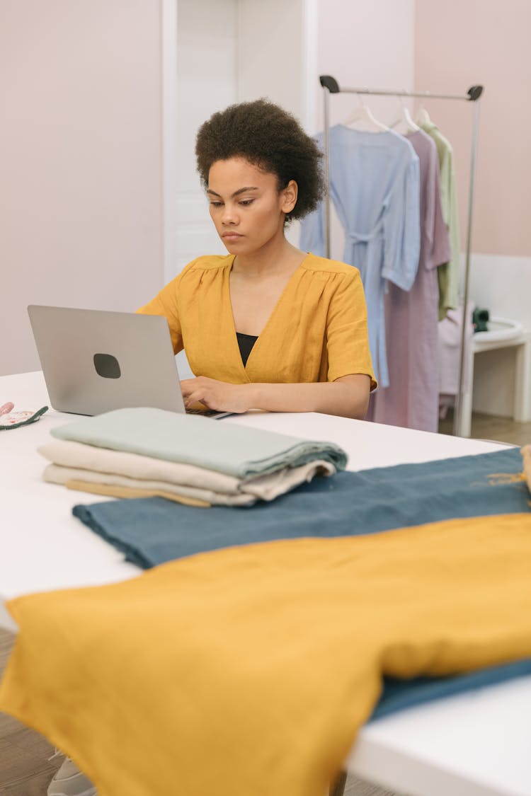 Woman In Mustard V Neck Shirt Using Laptop